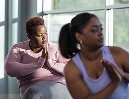 Three women doing yoga.