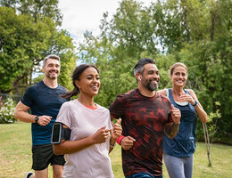 A group of four smiling joggers.