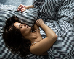 A woman asleep in bed.