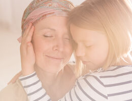 A child hugs a woman.