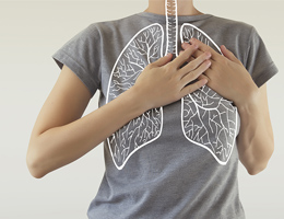 A drawing of lungs superimposed on the torso of someone wearing a gray T-shirt.