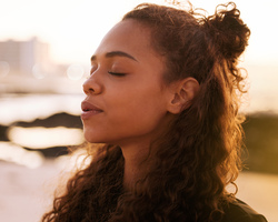 A woman with her eyes closed and a serene expression